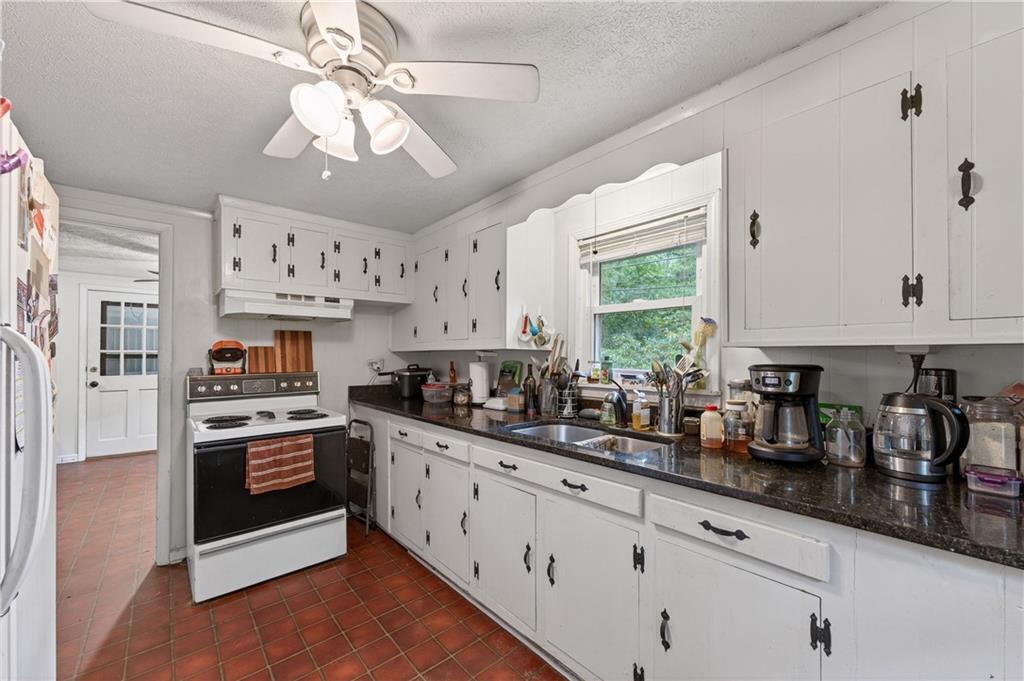 4399 Highway 411 Rydal, GA 30171 - Photo 2 of 37 a kitchen with stainless steel appliances granite countertop a sink a stove and cabinets