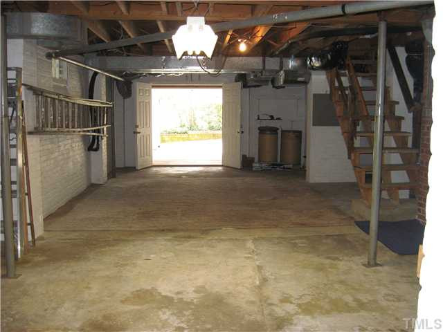 719 Runnymede Road Raleigh, NC 27607 - Photo 23 of 25 Large unfinished basement with garage has work shop, fireplace, washer dryer hook up, and lots of storage space. Basement