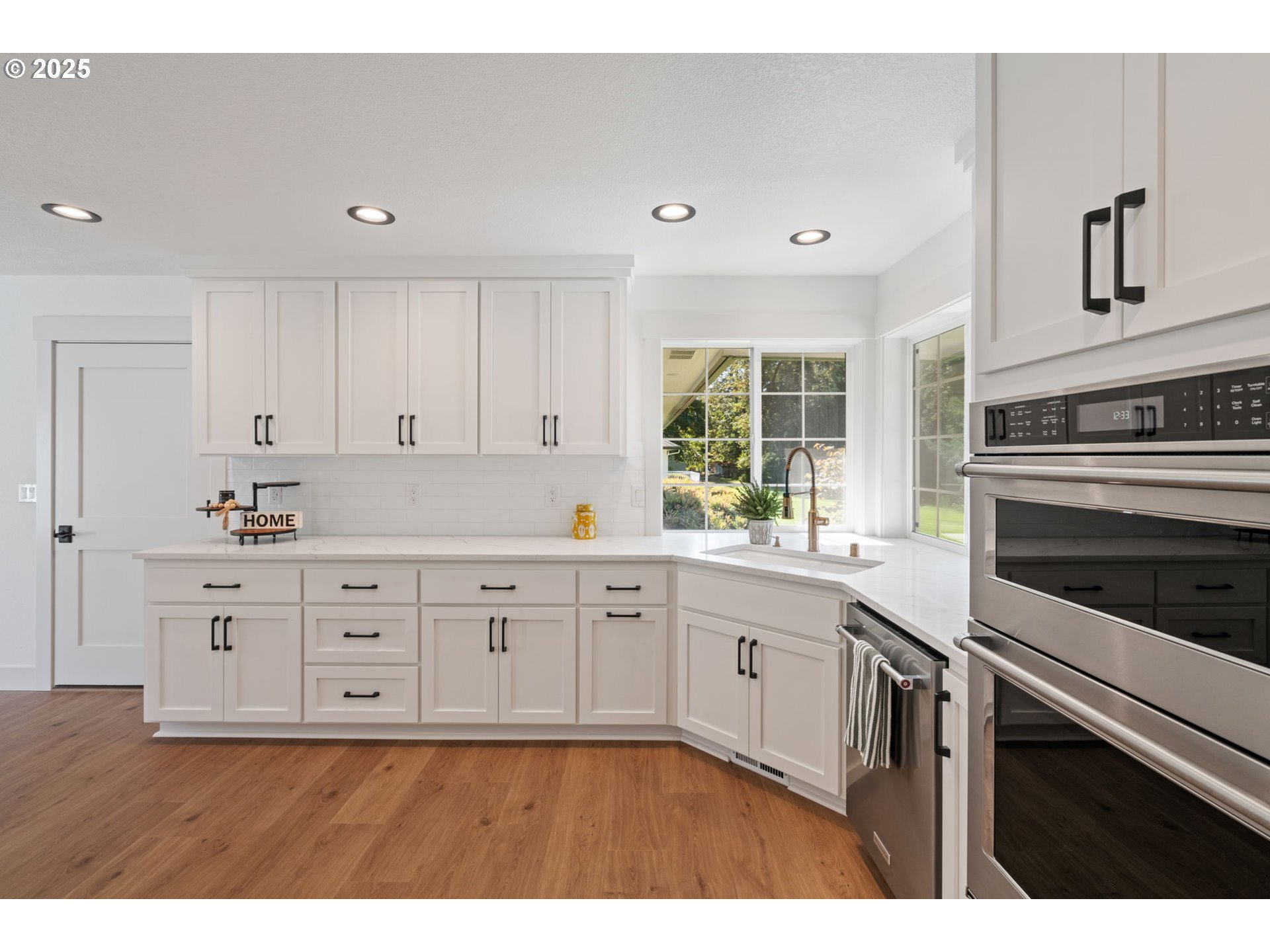 25600 Northeast 152nd Avenue Battle Ground, WA 98604 - Photo 15 of 48 a kitchen with granite countertop white cabinets and stainless steel appliances