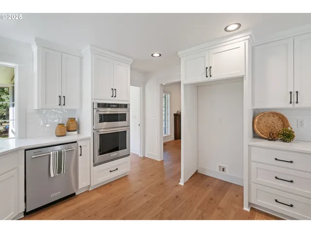 a kitchen with granite countertop white cabinets and appliances