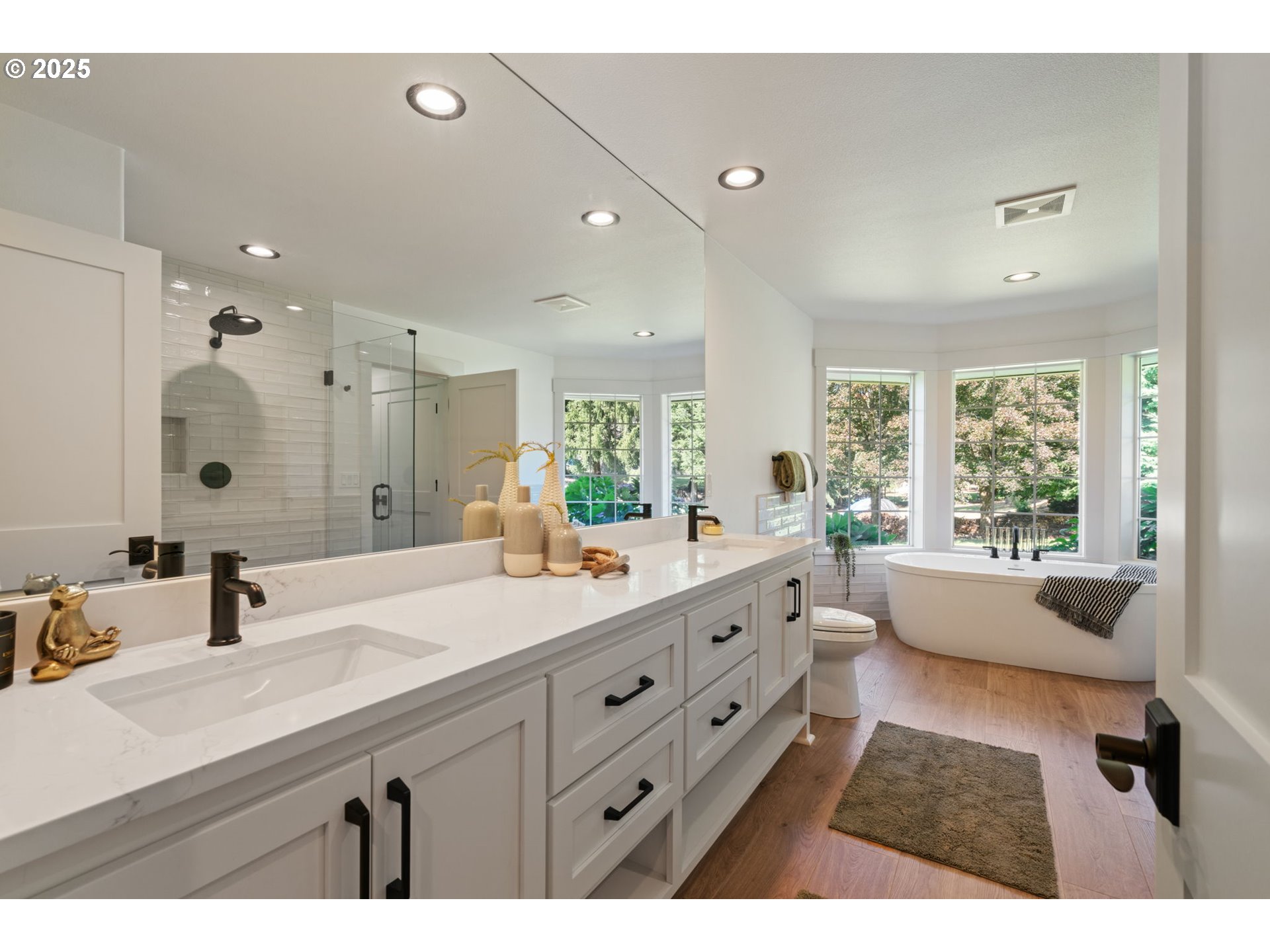 25600 Northeast 152nd Avenue Battle Ground, WA 98604 - Photo 19 of 48 a bathroom with a double vanity sink large mirror and a bathtub