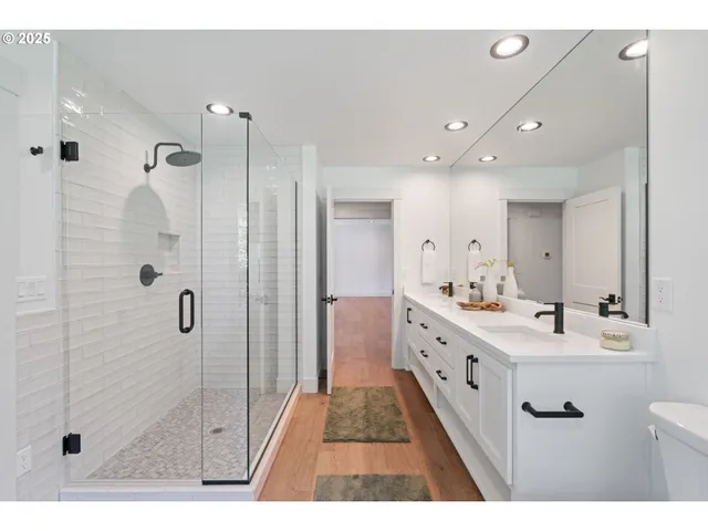 a bathroom with a double vanity sink mirror double and shower
