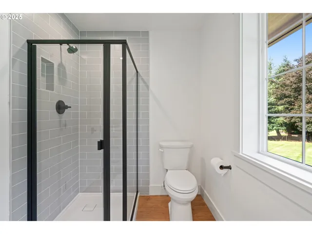 a bathroom with a toilet a sink and a shower