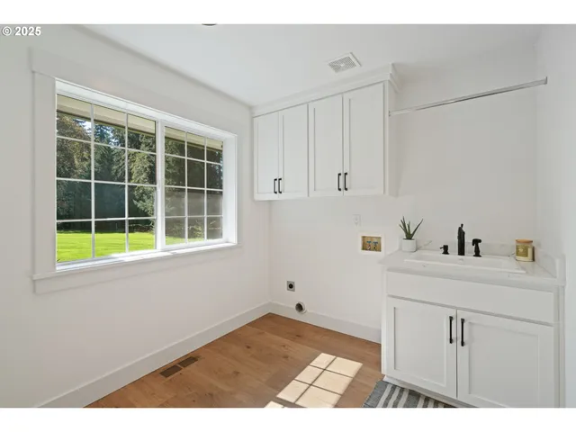 a kitchen with a sink cabinets and a window