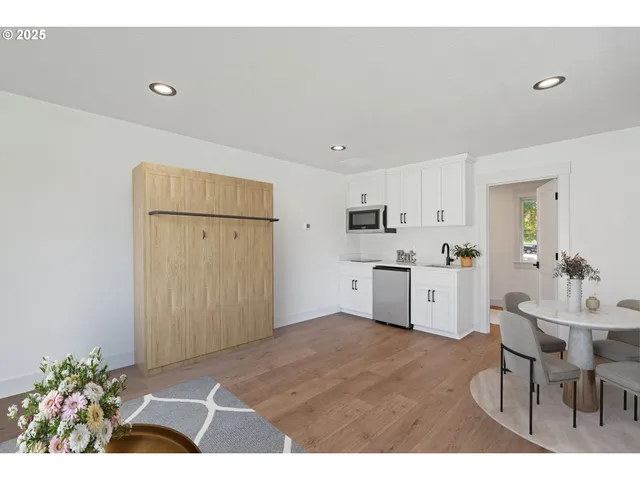 a kitchen with stainless steel appliances white cabinets and a sink