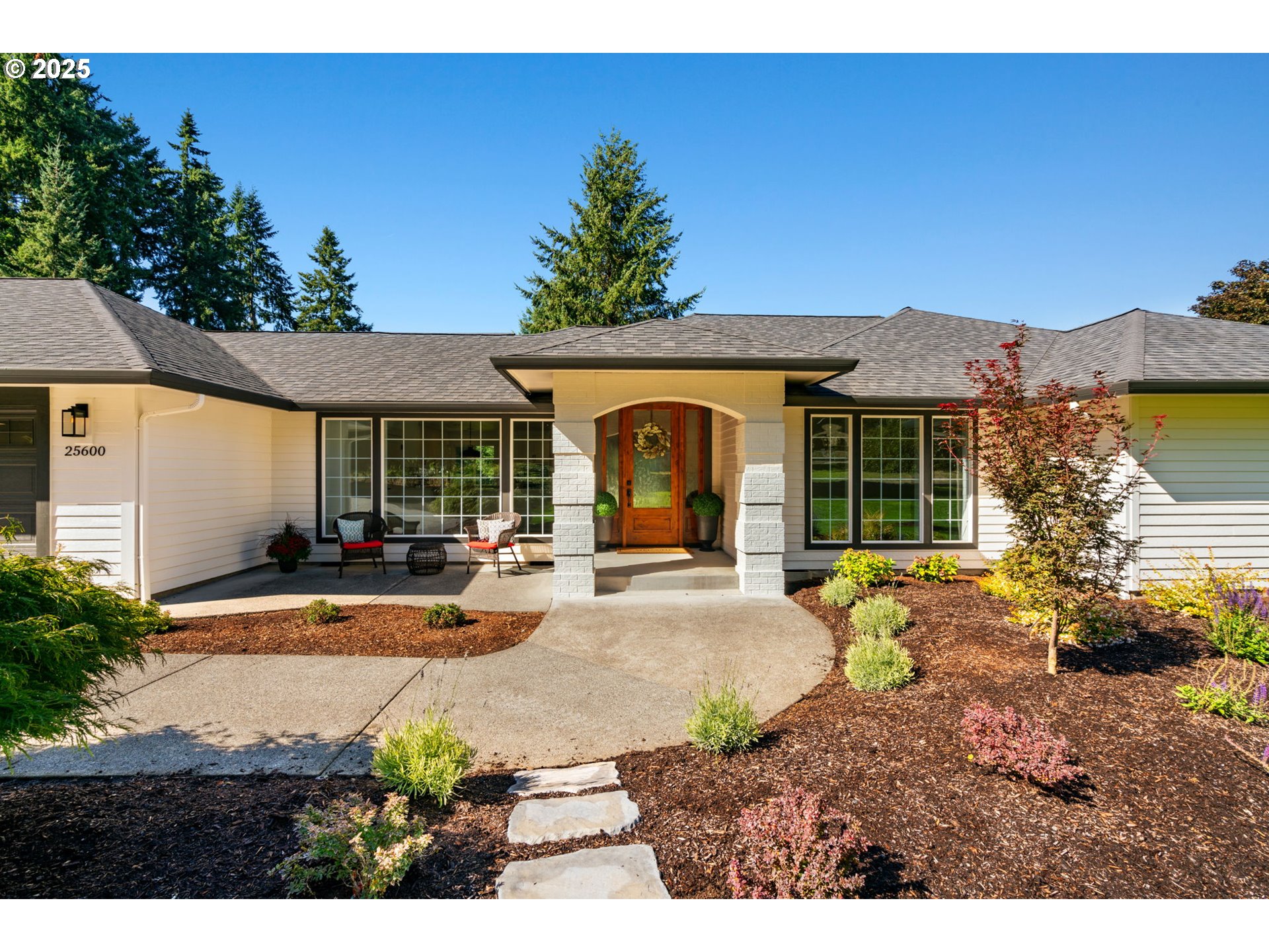 25600 Northeast 152nd Avenue Battle Ground, WA 98604 - Photo 4 of 48 a front view of a house with a garden and patio