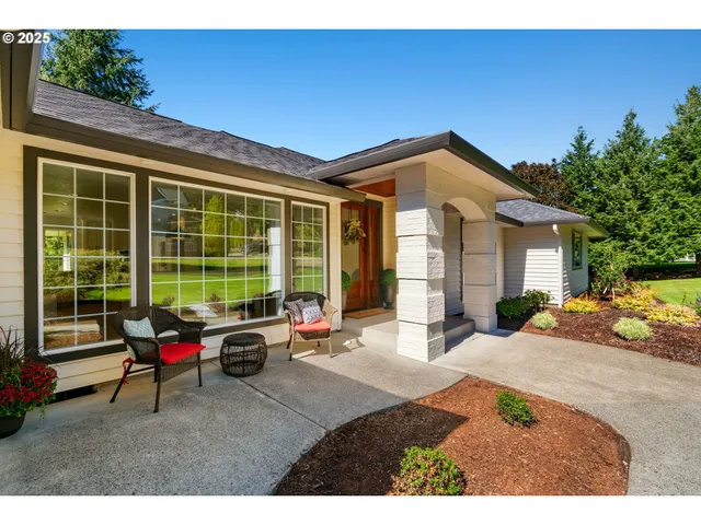 a building outdoor space with patio furniture and garden