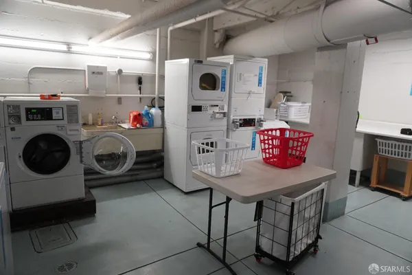 a utility room with dryer washer and a view of kitchen