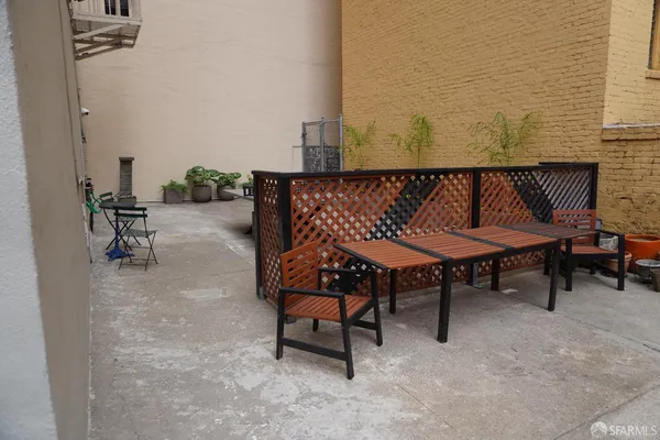 a balcony with table and chairs