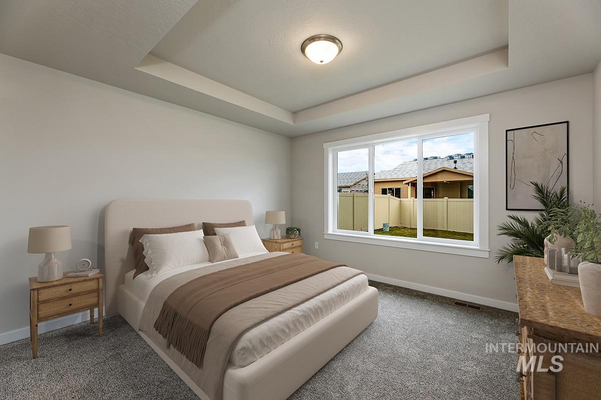 7080 South Gamely Avenue Meridian, ID 83642 - Photo 10 of 30 Bedroom with carpet and a raised ceiling