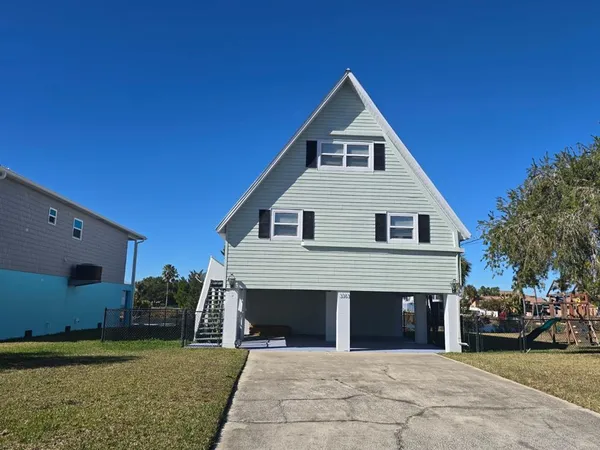 a view of a white house with a yard