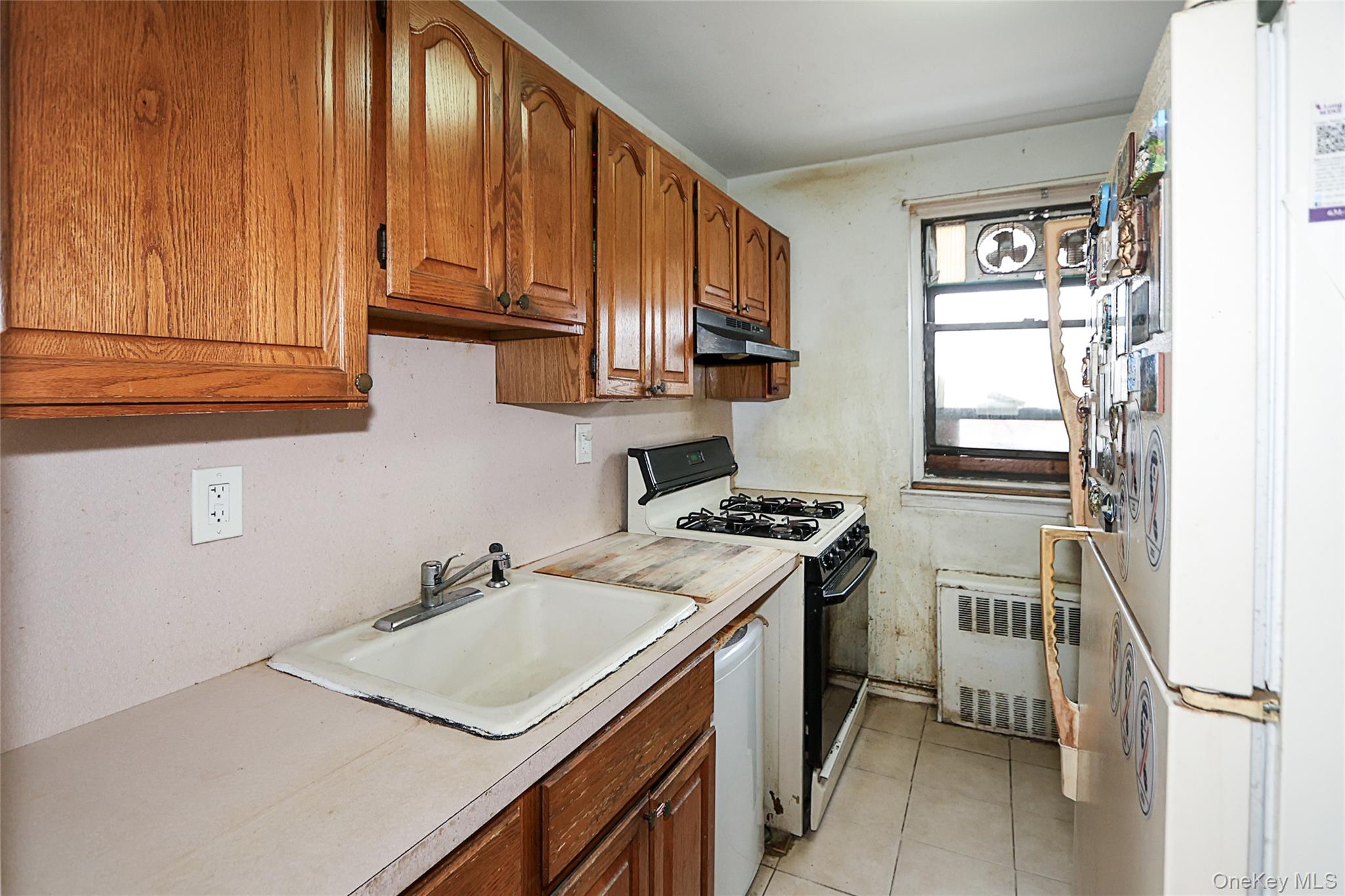 196-23 73rd Avenue, Unit 2 Queens, NY 11366 - Photo 11 of 19 a kitchen with stainless steel appliances granite countertop a sink stove and refrigerator
