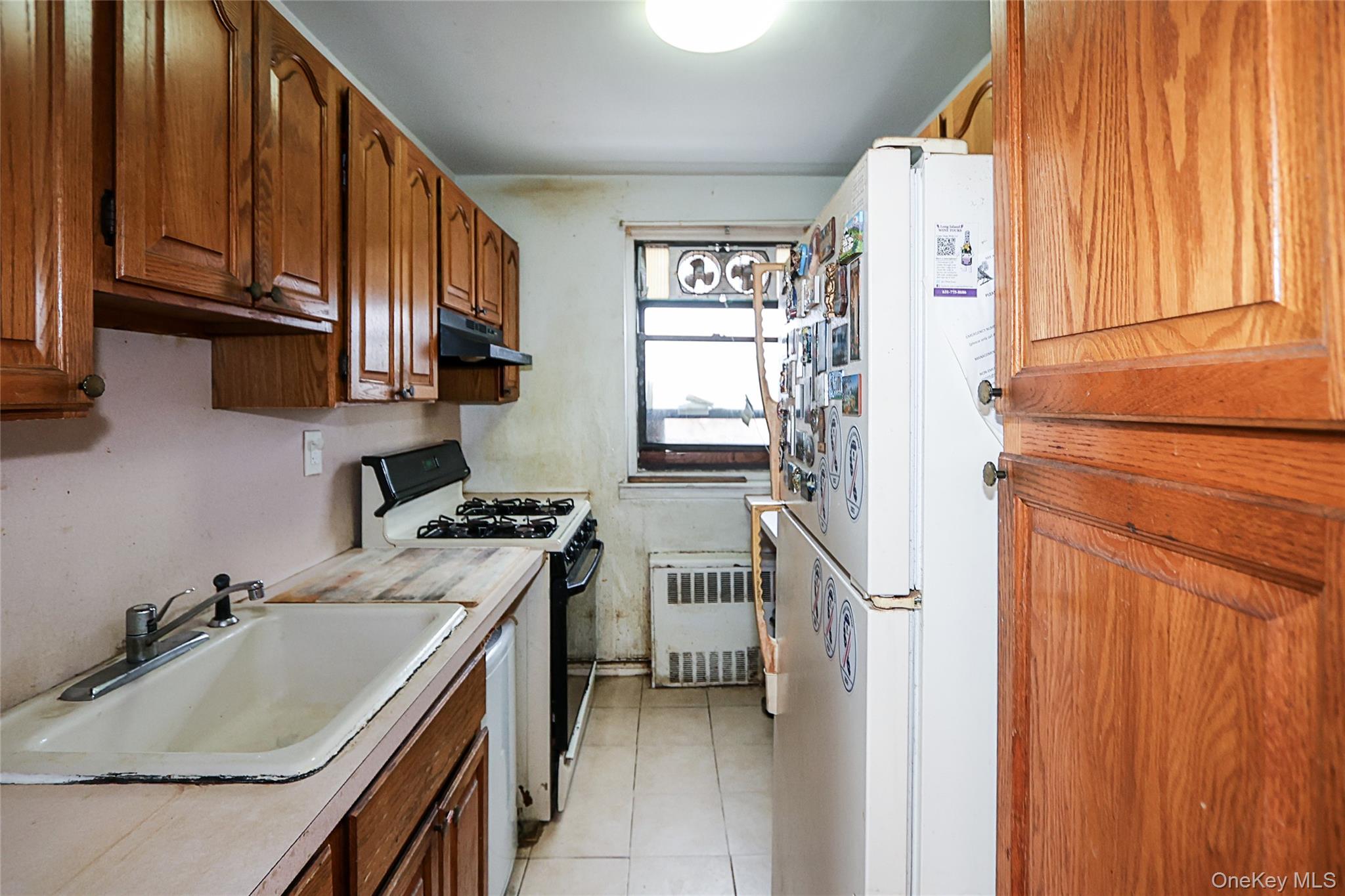 196-23 73rd Avenue, Unit 2 Queens, NY 11366 - Photo 12 of 19 a kitchen with a sink stove and refrigerator