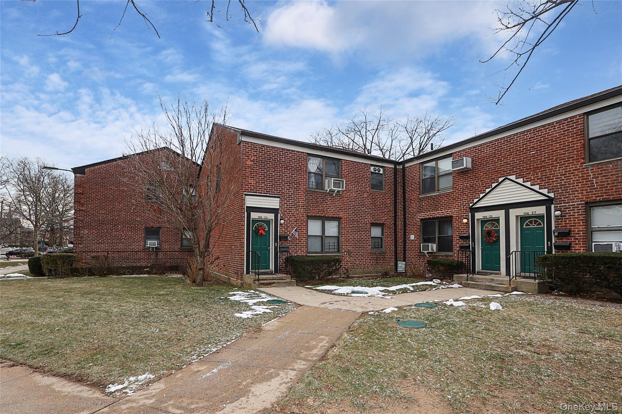196-23 73rd Avenue, Unit 2 Queens, NY 11366 - Photo 2 of 19 a front view of a house with a yard