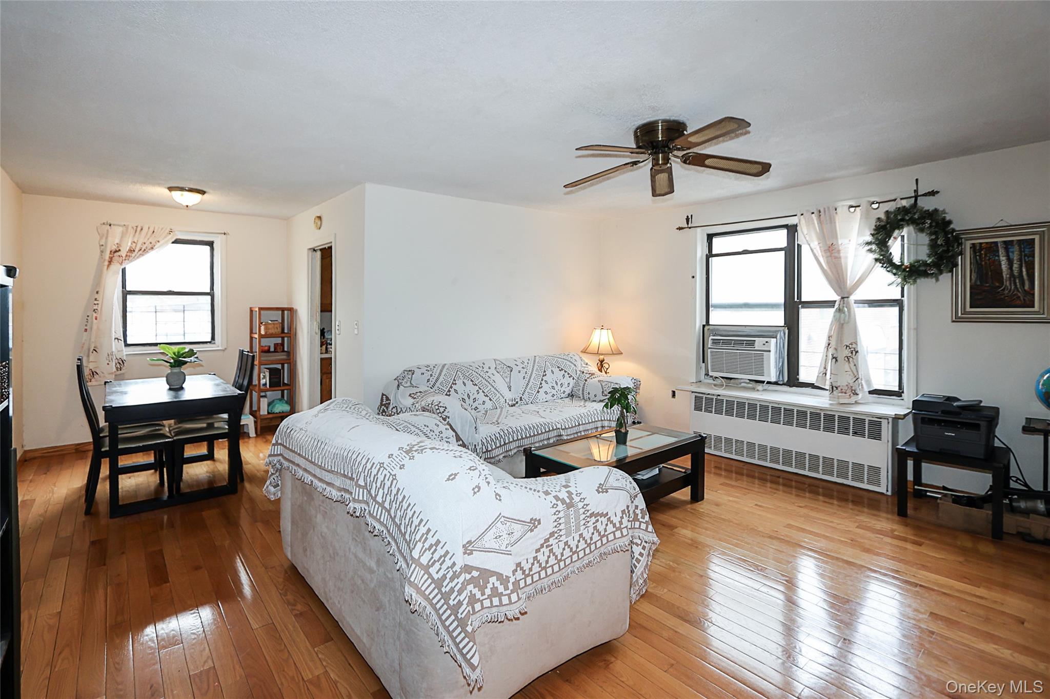 196-23 73rd Avenue, Unit 2 Queens, NY 11366 - Photo 4 of 19 a living room with furniture and a window