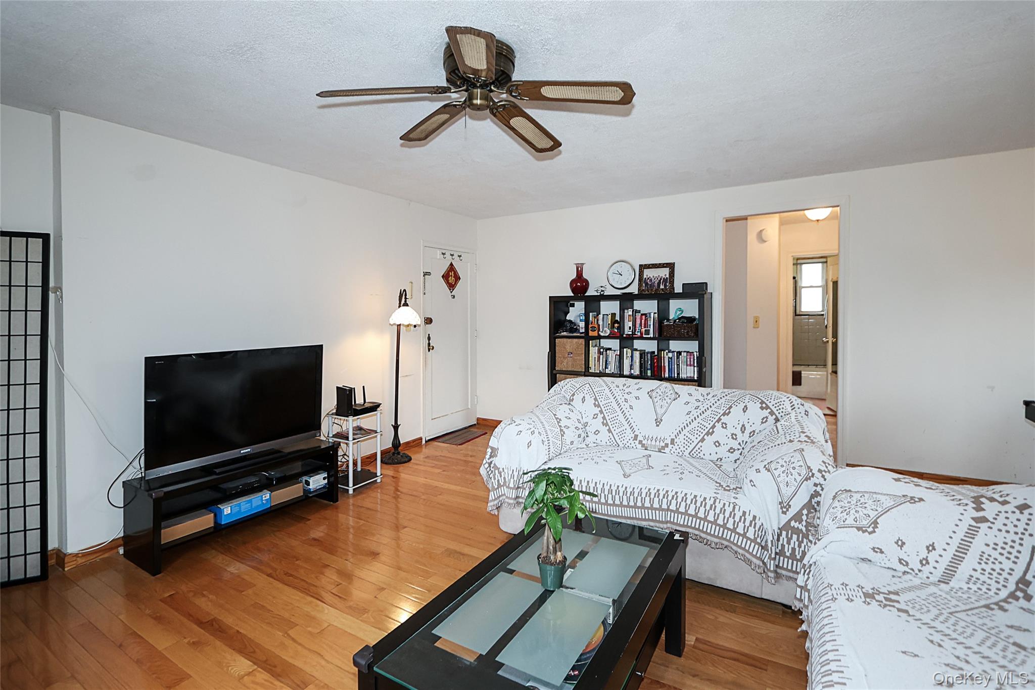 196-23 73rd Avenue, Unit 2 Queens, NY 11366 - Photo 6 of 19 a living room with furniture and a flat screen tv
