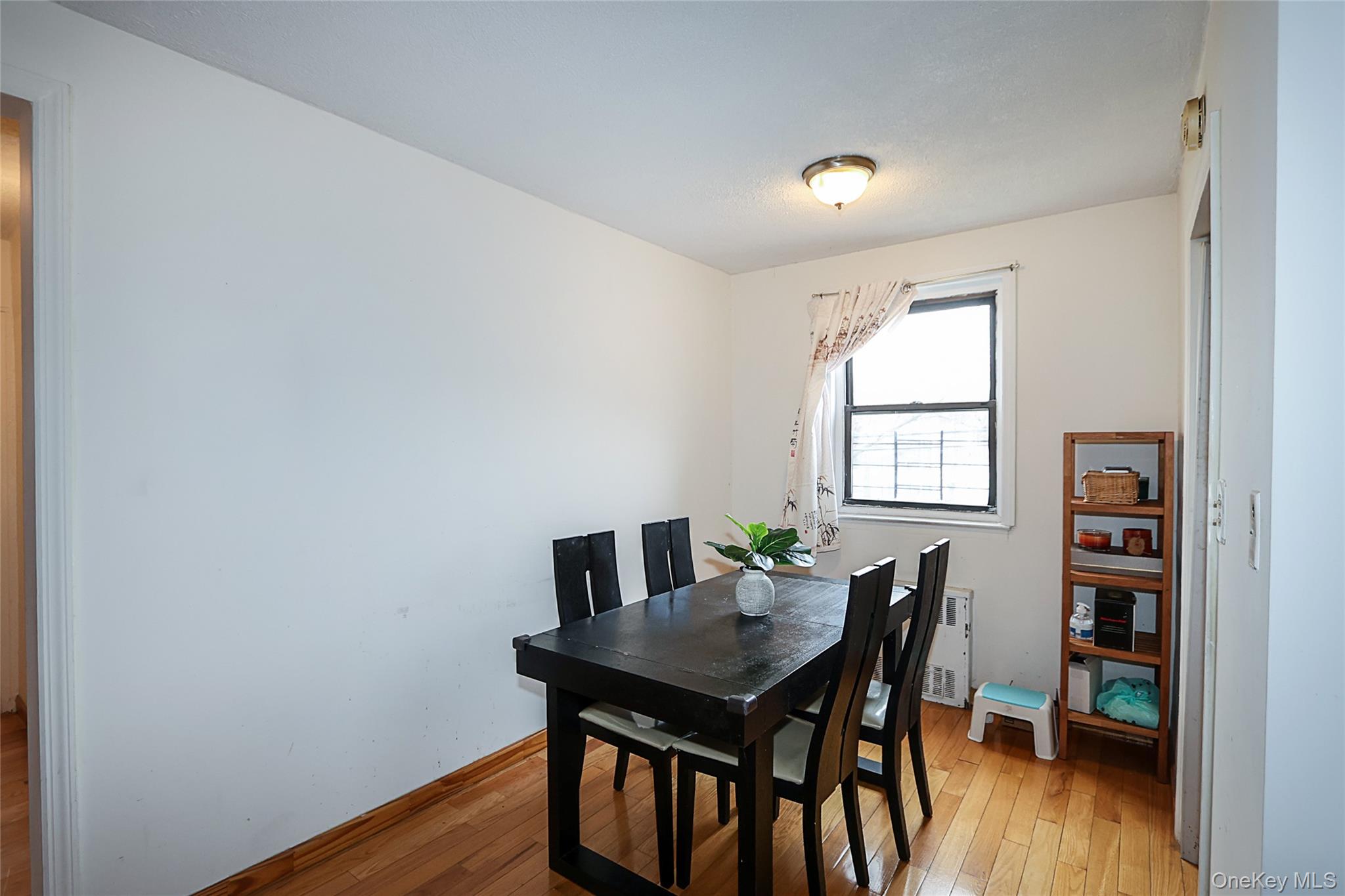 196-23 73rd Avenue, Unit 2 Queens, NY 11366 - Photo 10 of 19 a view of a dining room with furniture and wooden floor