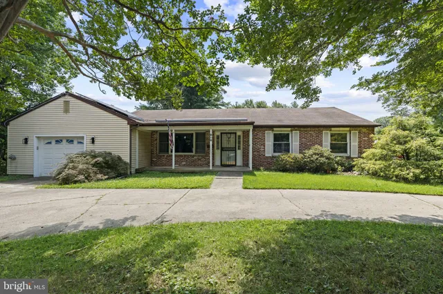 a front view of a house with a yard and porch