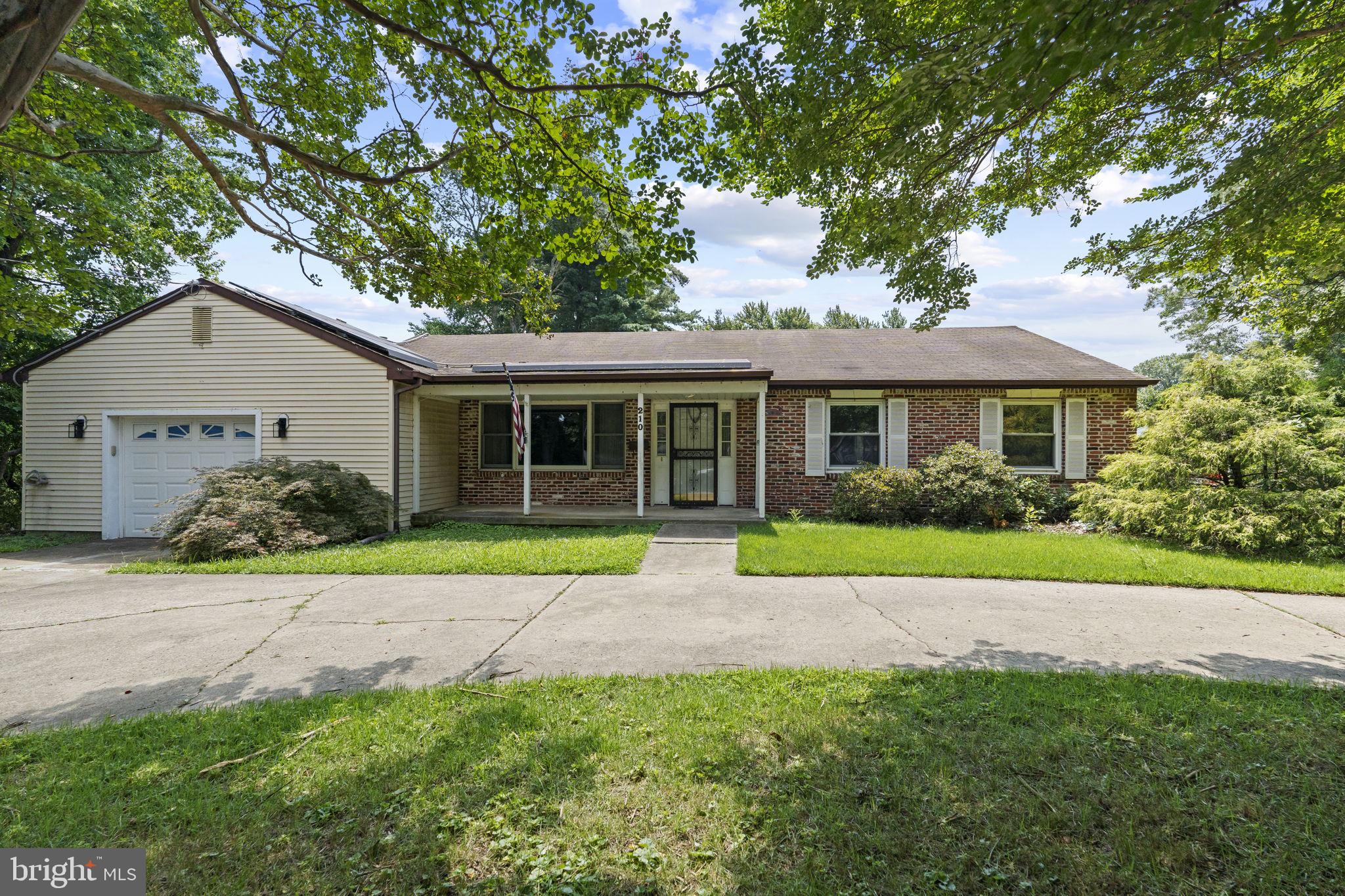 a front view of a house with a yard and porch