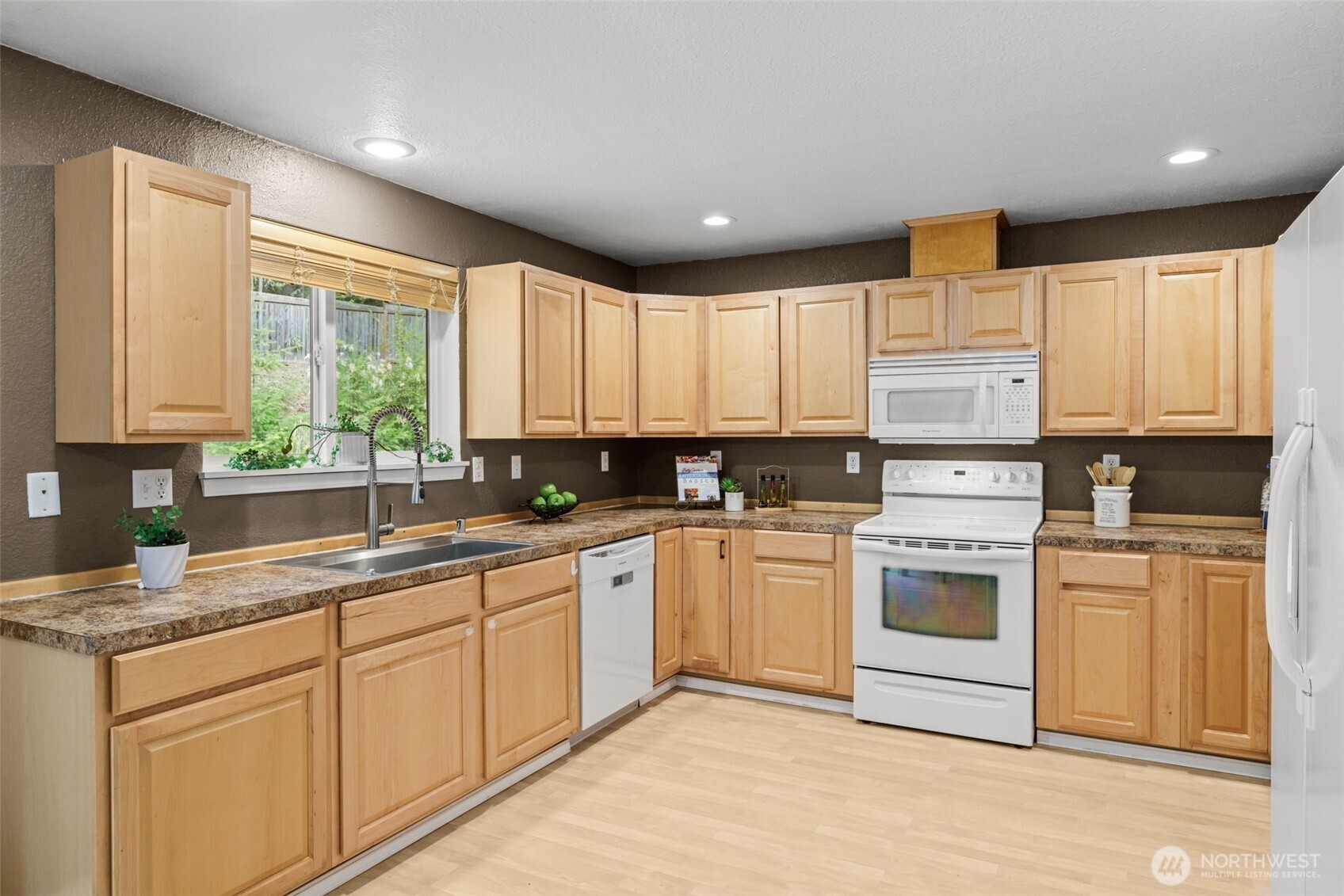 19221 Patterson Road East Orting, WA 98360 - Photo 13 of 40 a kitchen with white cabinets appliances a sink and a window