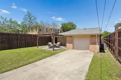 a view of a house with backyard and sitting area