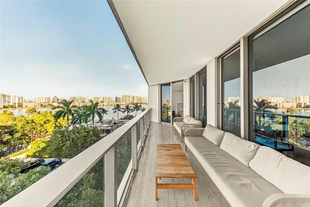 a balcony with furniture and a table