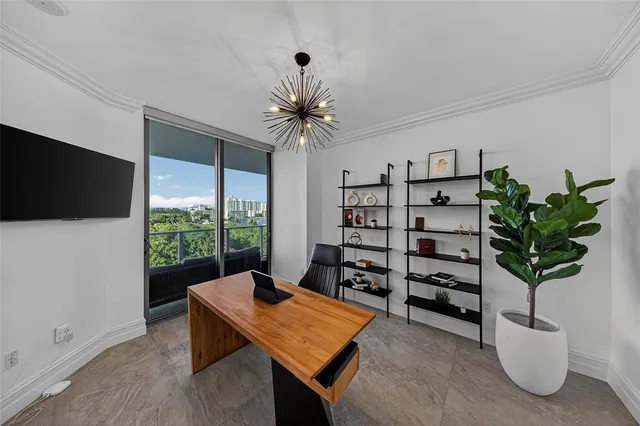 a living room with furniture a flat screen tv and a potted plant