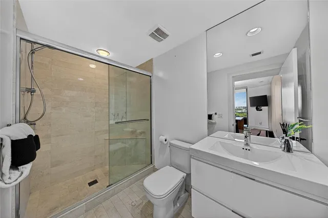 a bathroom with a sink toilet and shower