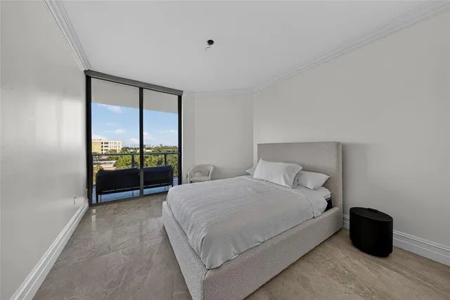 a bedroom with a bed and large window
