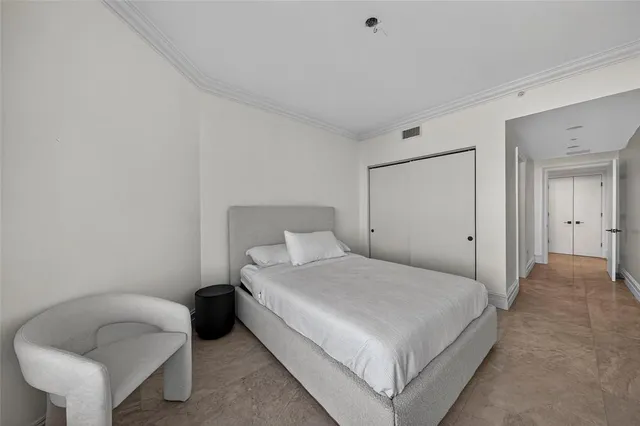 a bedroom with a bed and a chair