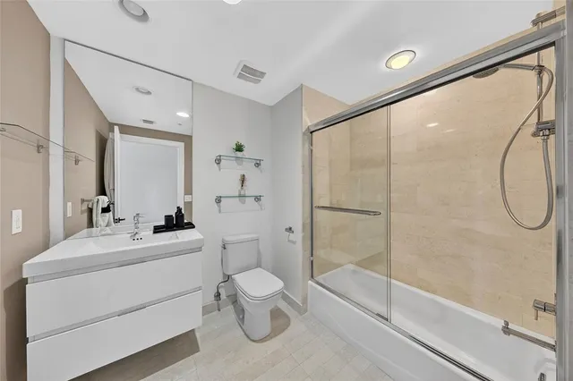 a bathroom with a toilet sink and shower