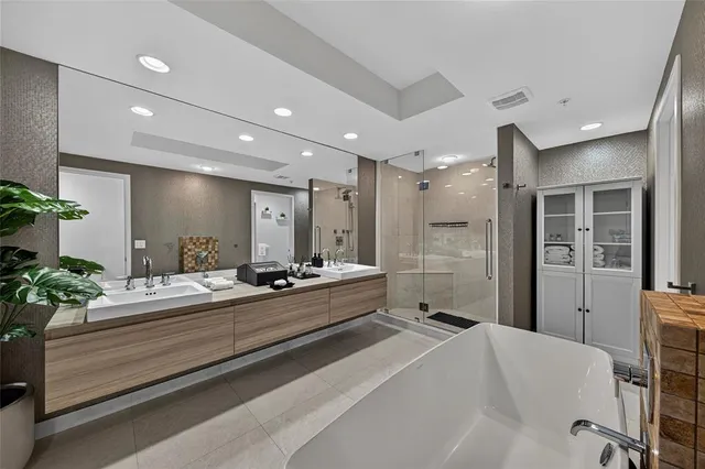 a large bathroom with a tub and shower