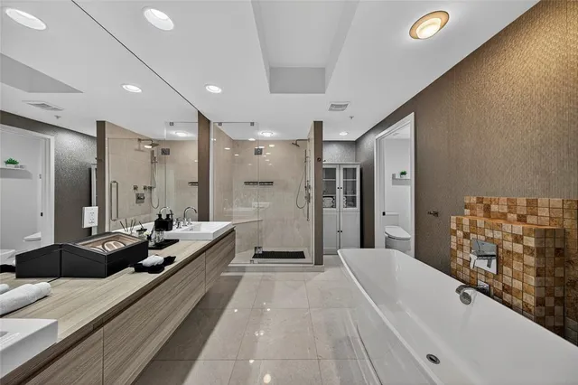 a bathroom with a bathtub and a shower