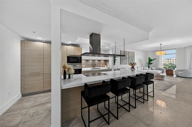 a kitchen with stainless steel appliances a dining table and chairs