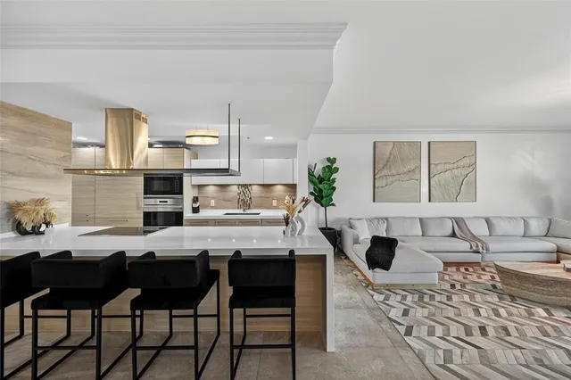 a kitchen with a table chairs stove and refrigerator