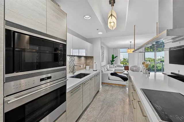 a kitchen with stainless steel appliances kitchen island granite countertop a stove and a sink