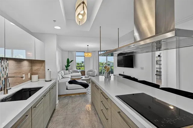 a kitchen with stainless steel appliances a sink a stove and a wooden floors