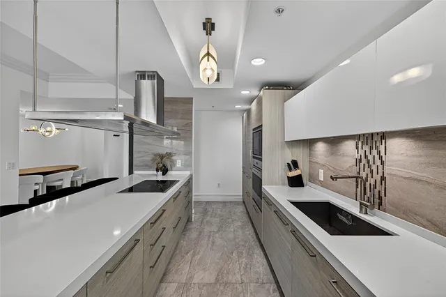 a kitchen with stainless steel appliances a sink and stove