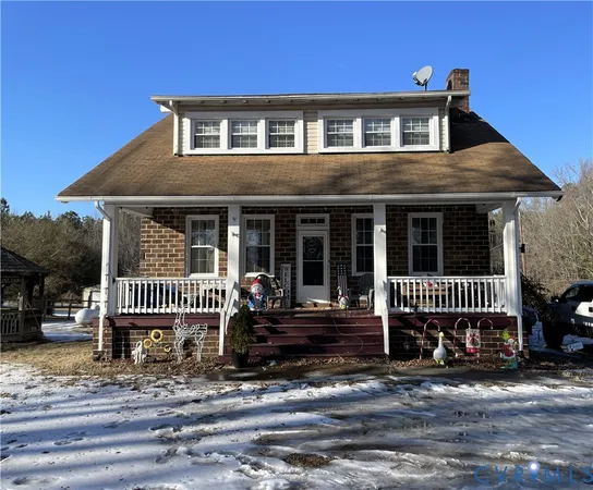 a view of a house with a yard and furniture