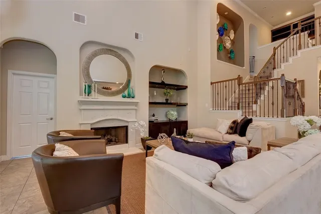 a living room with furniture a fireplace and gym equipment