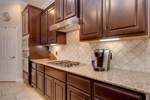 a kitchen with stainless steel appliances granite countertop a sink stove and cabinets