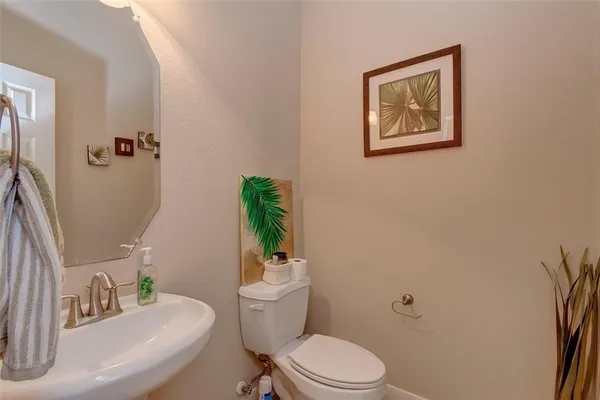 a bathroom with a toilet a sink and a mirror