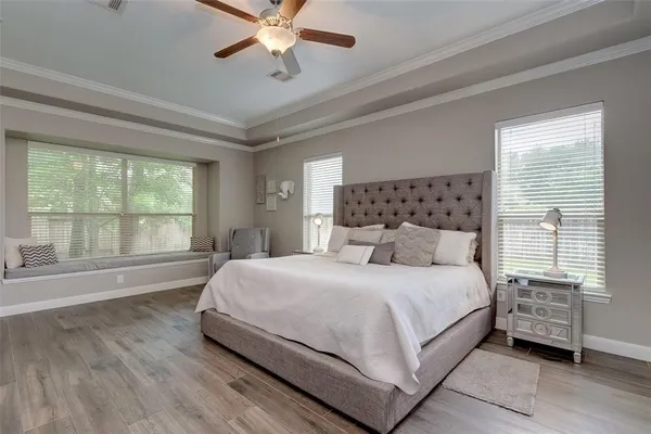 a bedroom with a large bed and a large window