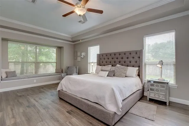 a bedroom with a large bed and a large window