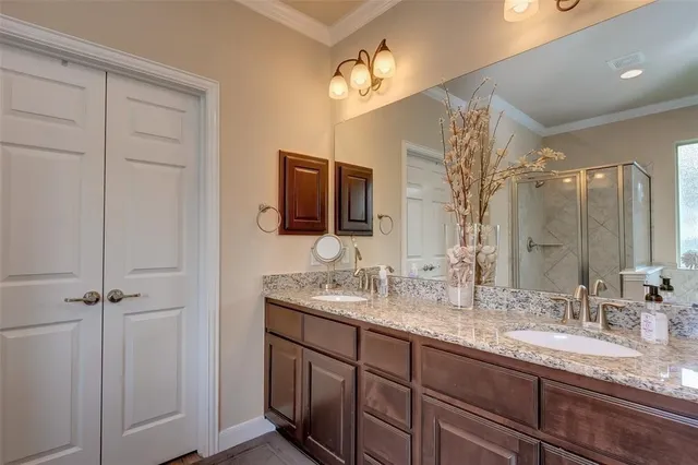 a bathroom with double sink and a mirror