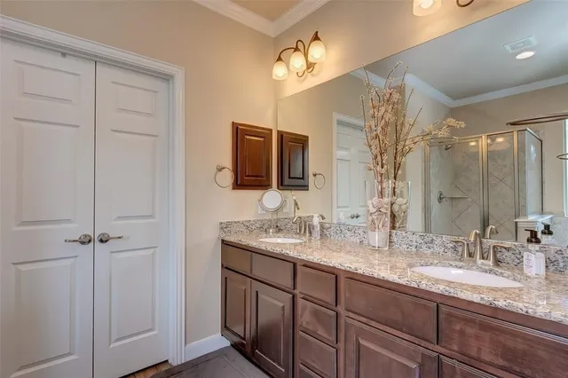 a bathroom with double sink and a mirror