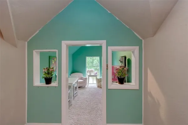 a view of a porch with furniture and garden