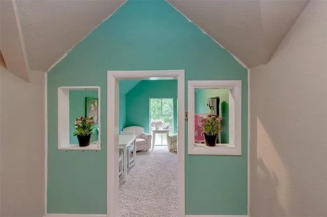 a view of a porch with furniture and garden