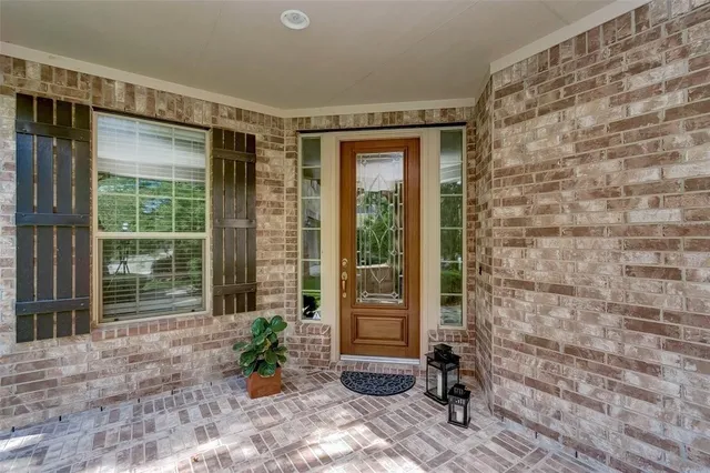a view of front door of house with potted plant
