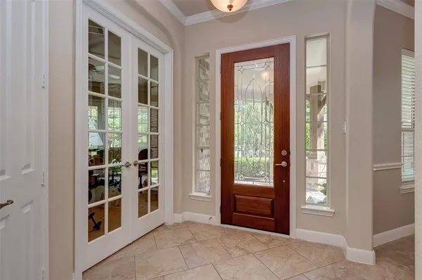 a view of an entryway with wooden floor and windows